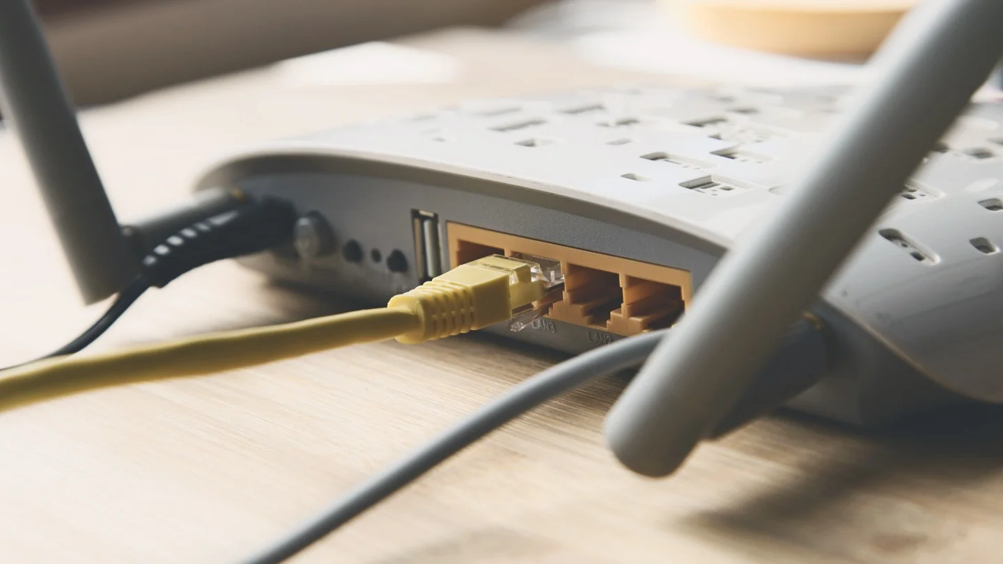 Optimum router (if available); or someone setting up a router, internet cables, etc.