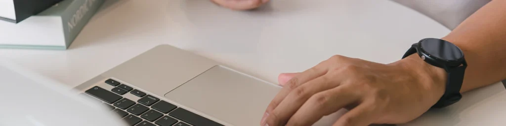 Close-up of hand using a laptop computer.