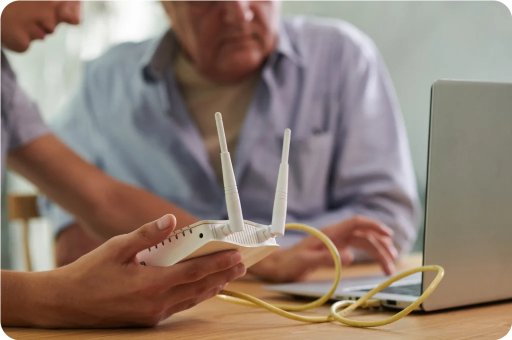 Two people setting up a wireless router.