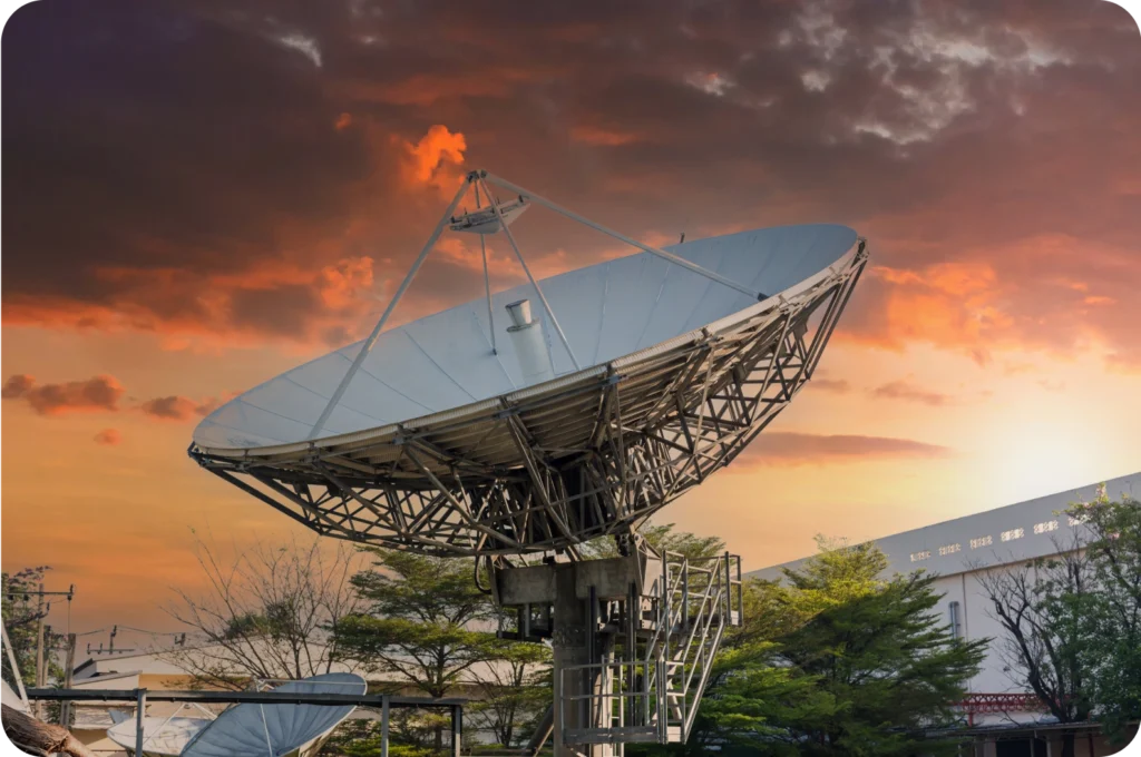 Satellite dish against a sunset sky