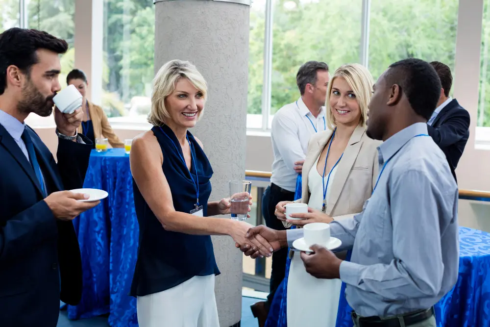 Networking event with professionals sharing conversations.